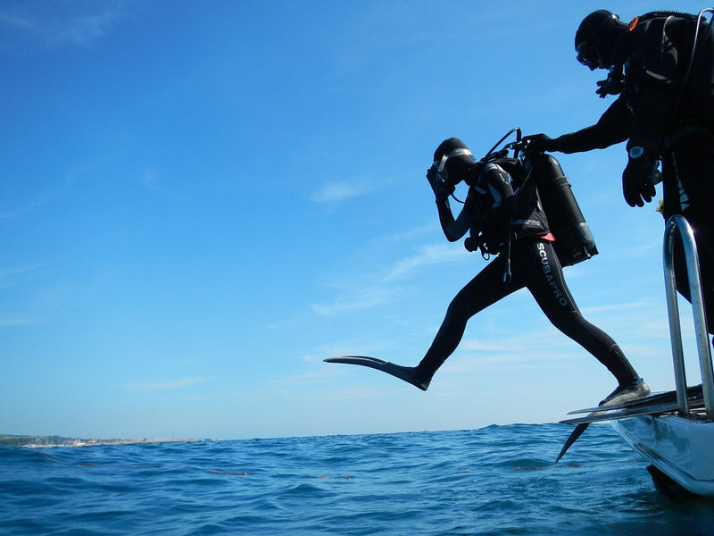 Diver jumping off boat